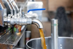 Maple syrup flowing out of a tap